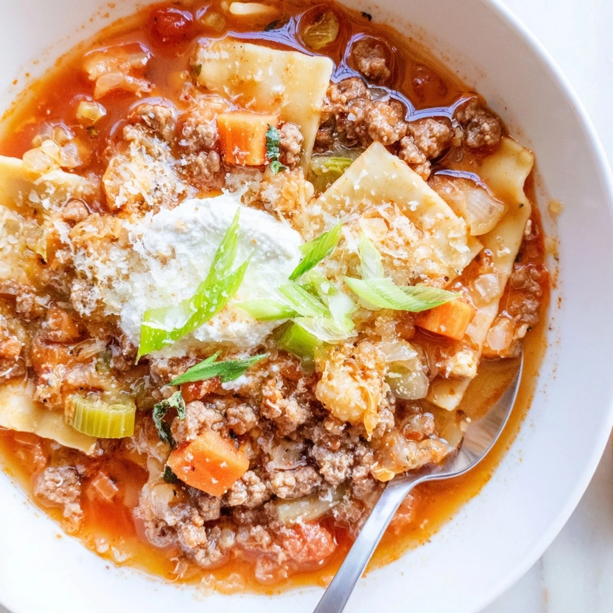 Savory and comforting Lasagne Soup with Kimchi Crunch topped with melting cheese.  