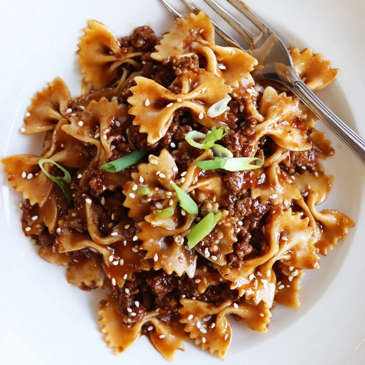 Deliciously caramelized Korean BBQ Beef Bowtie Pasta served in a bright dish.  