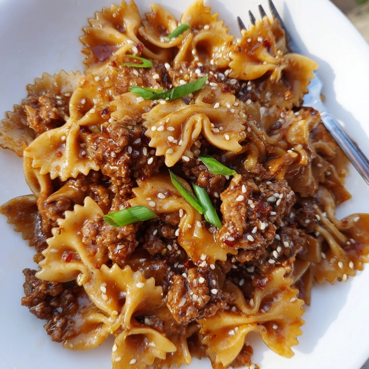 Comforting Korean BBQ Beef Bowtie Pasta with crunchy scallions and toasted seeds.