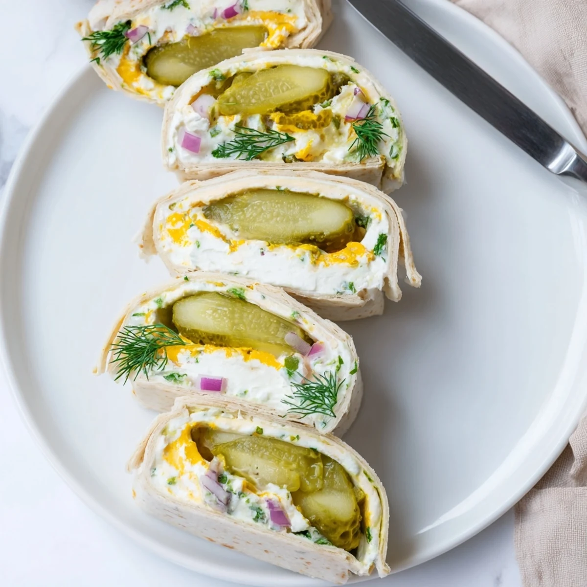 Delicious Pickle-in-a-Blanket featuring tangy dill pickles and creamy cheese wrapped warmly.  