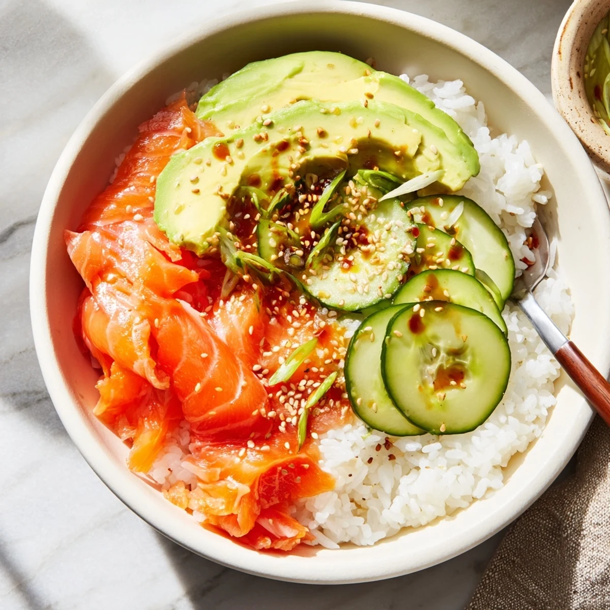 Vibrant leftover salmon and rice bowl garnished with pickled ginger and sesame seeds.