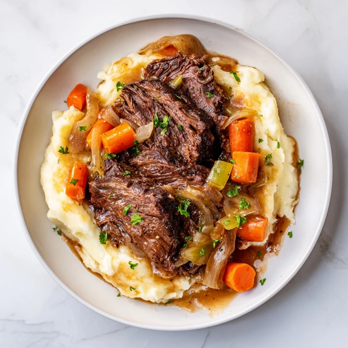 Tender, fall-apart Slow Cooker Pot Roast with rich gravy served over creamy mashed potatoes.
