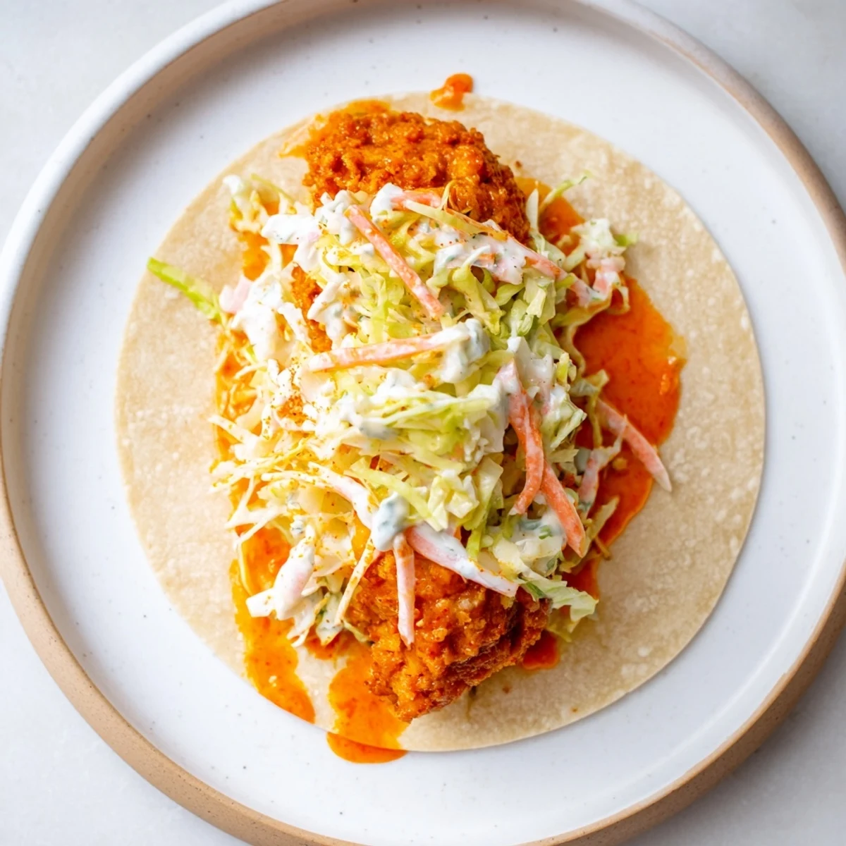 Crispy Buffalo Chicken Smash Burger Tacos sizzling on a griddle, ready to be flipped and served.