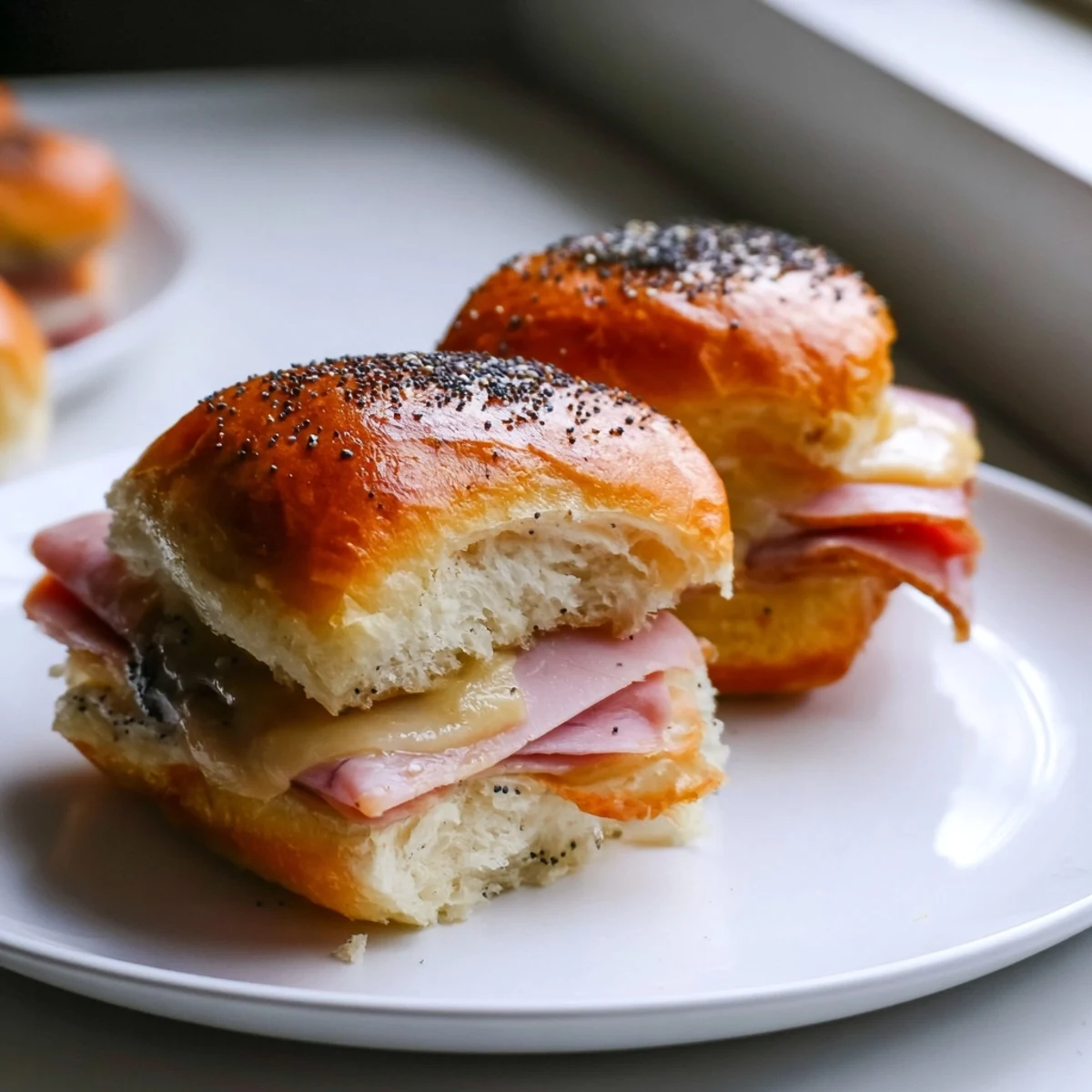 Golden-topped Budget-Friendly Ham & Cheese Sliders, bubbling with melted cheese and savory ham, perfect for sharing.