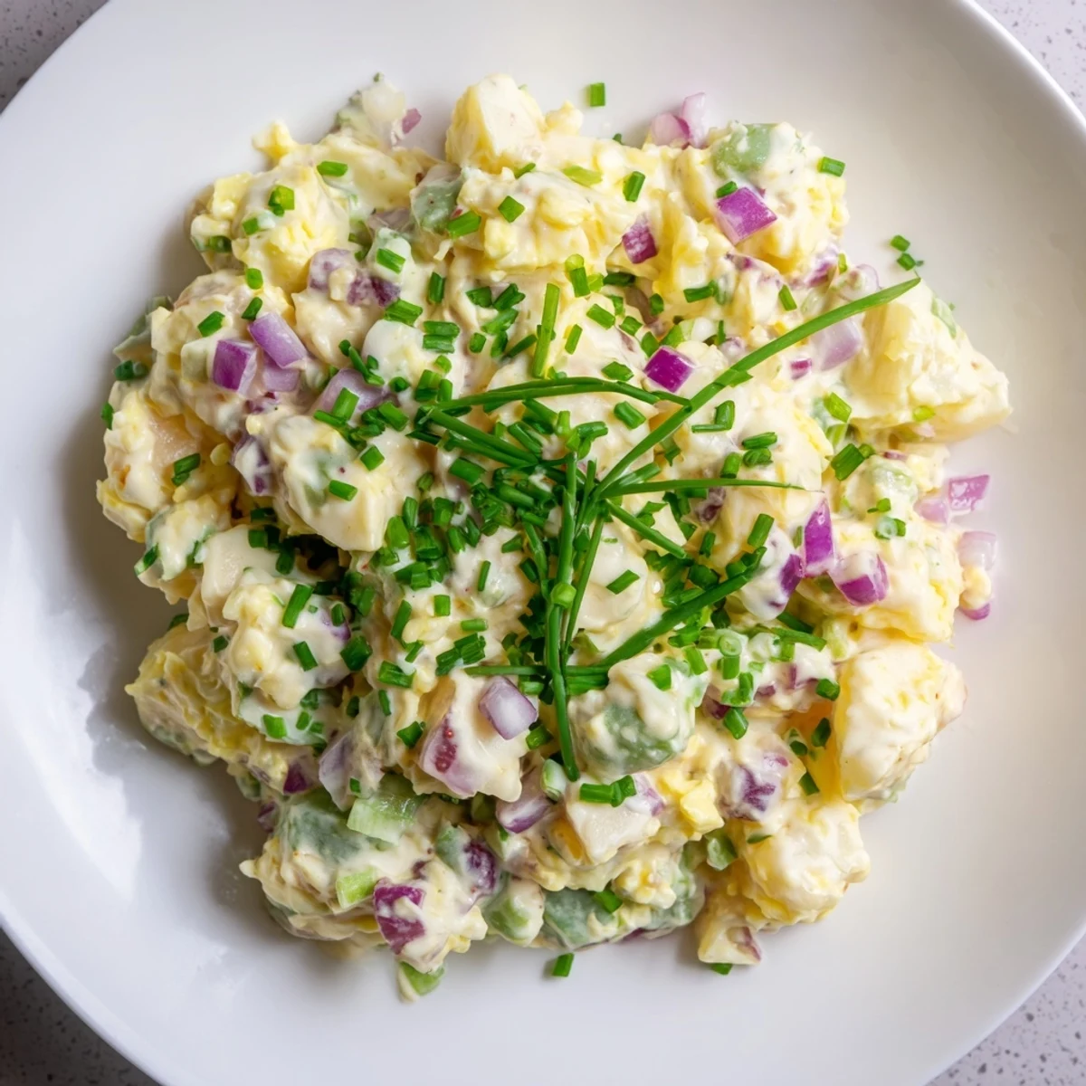This creamy Chopped Egg and Potato Salad features tender potatoes mixed with fresh herbs and a tangy dressing.
