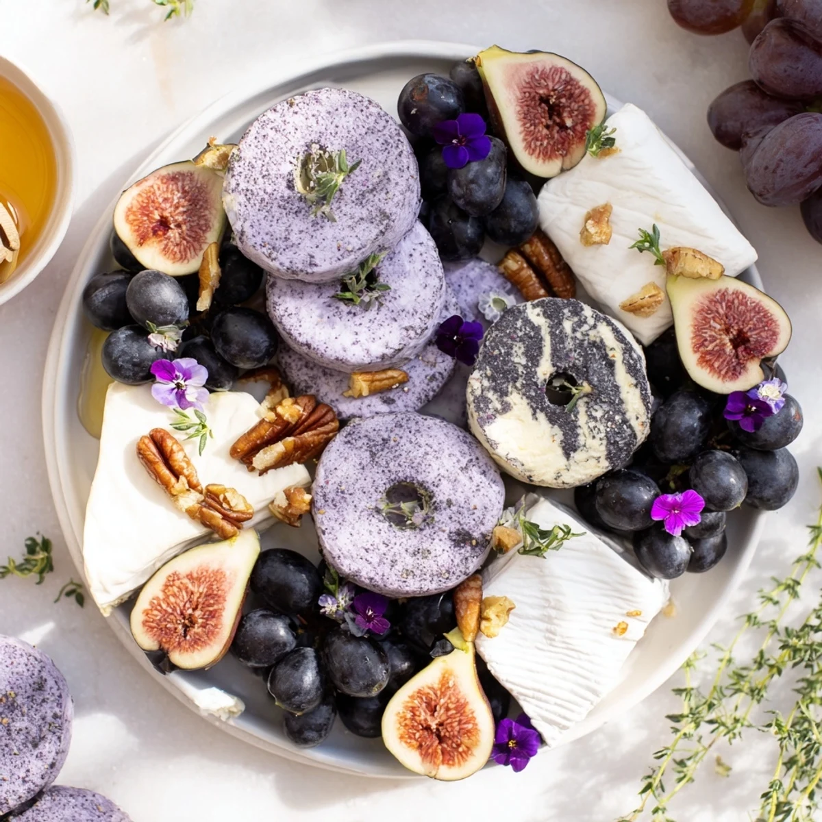 A beautifully arranged Lavender Haze cheese board showcasing brie, grapes, and candied nuts, perfect for serving.