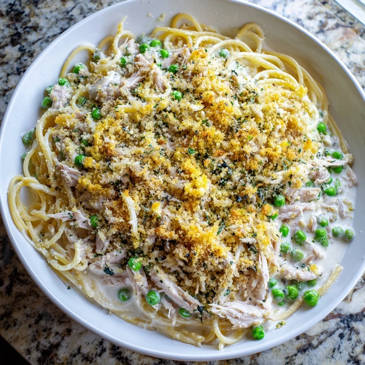 Golden-brown Turkey Tetrazzini bake bubbling in a dish, ready to serve with a creamy sauce.