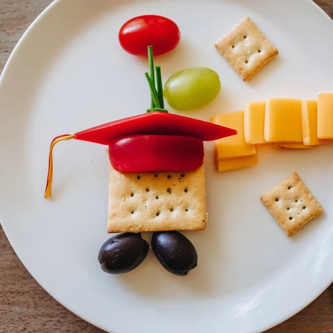 Graduation Cap Platter: A vibrant display with crackers, cheese, and fresh veggies to celebrate.