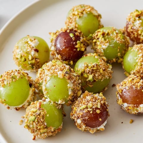 Elegant Sparkling Grape Cluster Appetizer with creamy cheese and toasted nuts, glistening on a serving platter.
