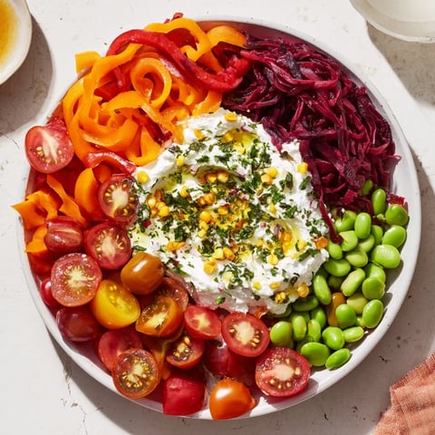 The Prism Burst salad, a rainbow of fresh veggies, is beautifully fanned out from the white ricotta base.