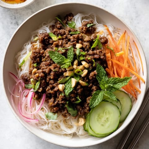 Delicious lemongrass beef noodle bowls featuring vibrant veggies and tasty nuoc cham.  