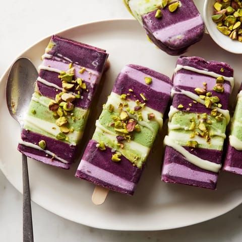 Vibrant ube and nutty pistachio ice cream bars topped with chopped pistachios.  