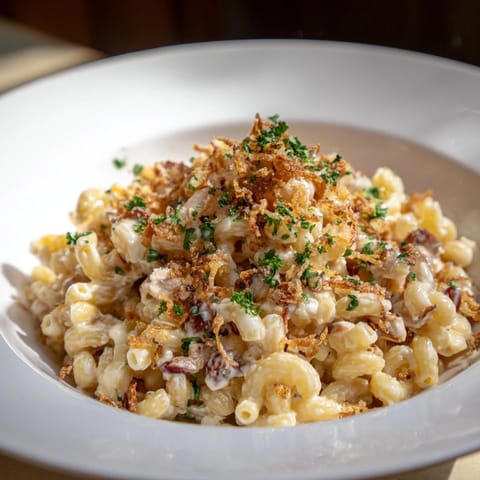 A close-up of creamy One-Pot Honey BBQ Chicken Mac and Cheese, boasting tender chicken pieces.