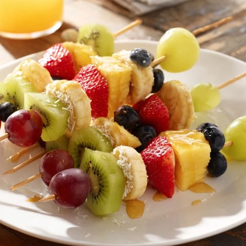 A close-up of delicious Easy Festive Fruit Kabobs, showcasing fresh, colorful fruit bursting with sweetness.