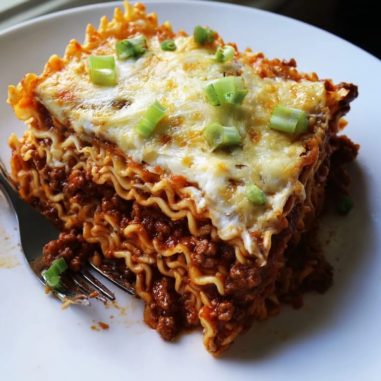 Comforting spicy ramen lasagna with rich ground pork and creamy cheese layers.  