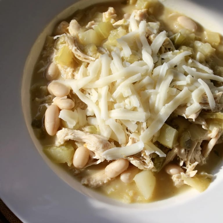 Warm, creamy 35-Minute White Cheddar Apple Chicken Chili in a bowl, perfect for a cozy supper.