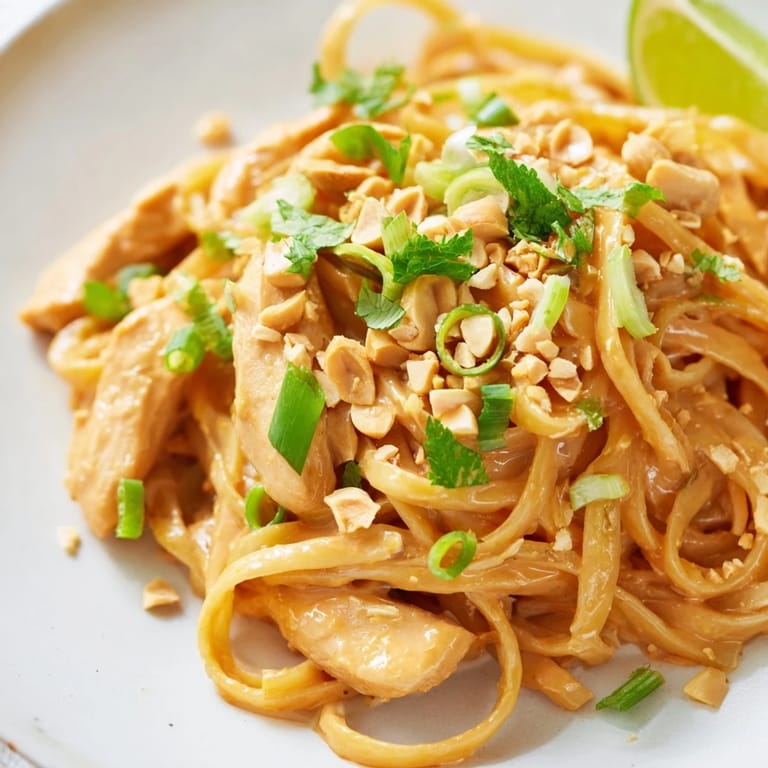 Tender chicken and linguine coated in creamy peanut sauce, a delightful Thai Peanut Chicken Pasta dinner.