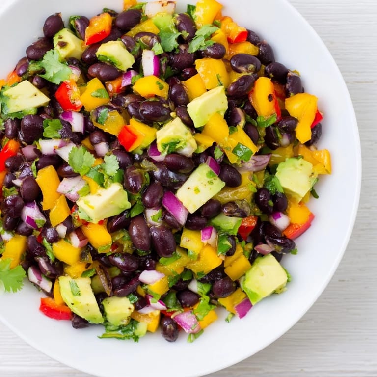A bright overhead shot displays the flavorful Southwest Black Bean Salad bursting with fresh ingredients.