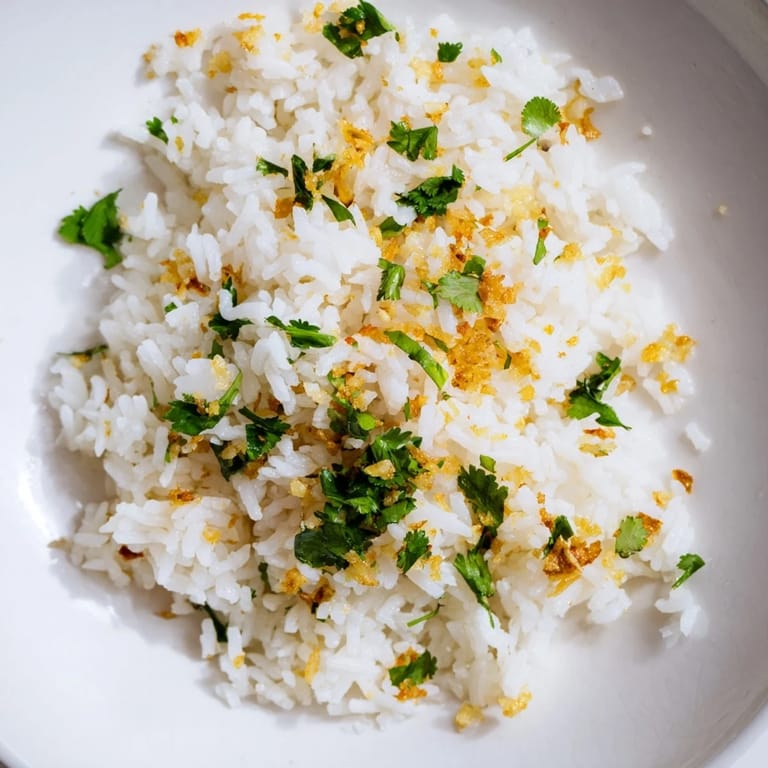 Steamed jasmine rice infused with aromatic garlic oil and garnished with scallions, perfect beside a colorful stir-fry.
